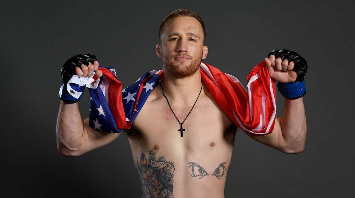 Photo of MMA fighter, Justin Gaethje holding American flag.